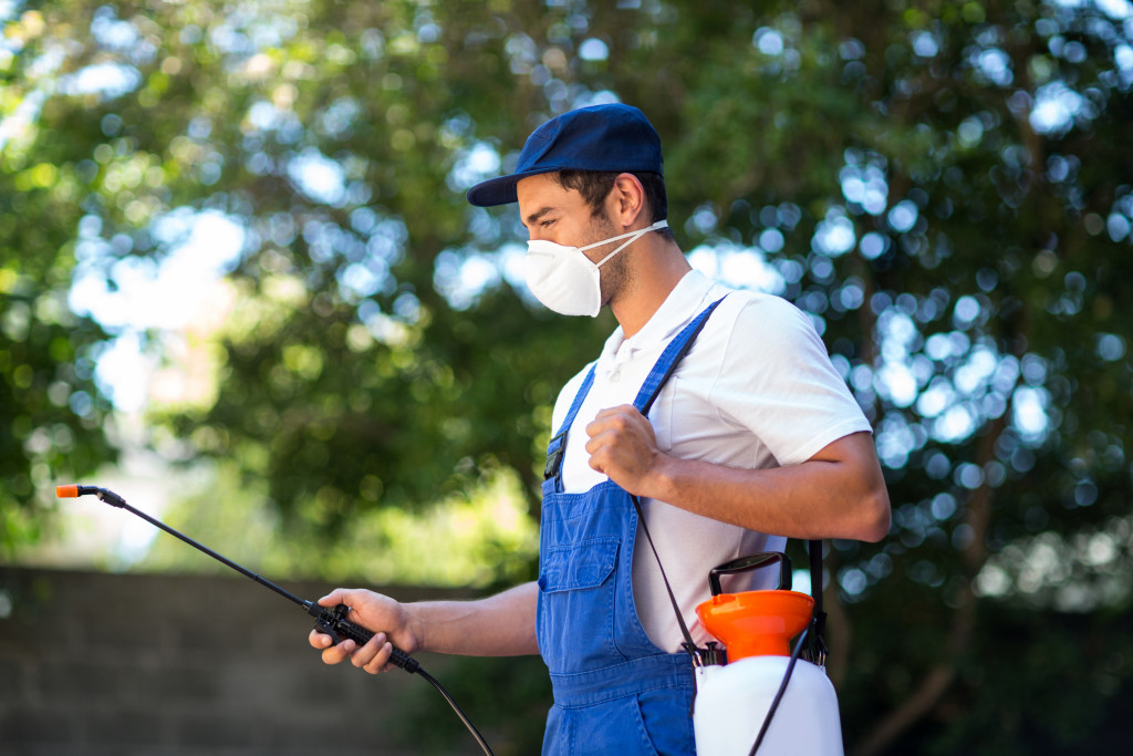 man spraying pesticides 