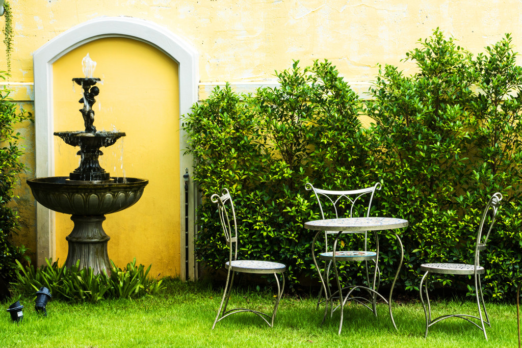 white chair in the garden and a fountain