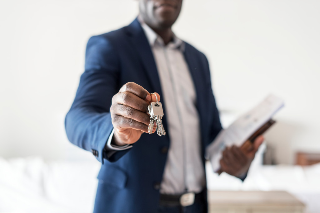 A real estate agent handing over the keys to a new house