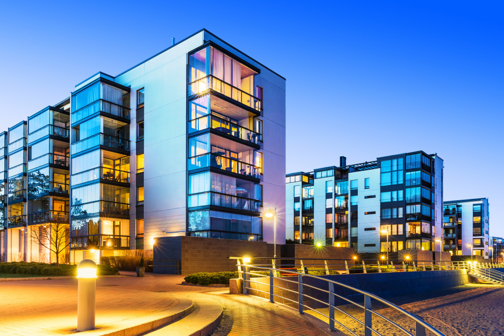 At night, an outside building curb is illuminated by different types of lights.