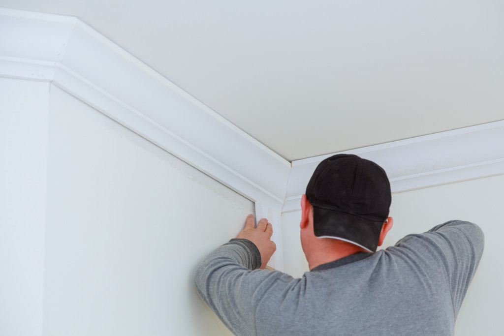 A man adding molding to homes