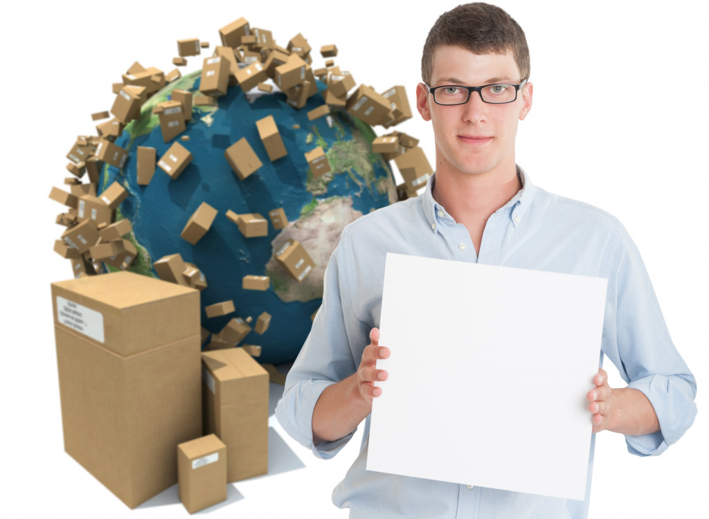 Young man holding a blank board with an international transport background