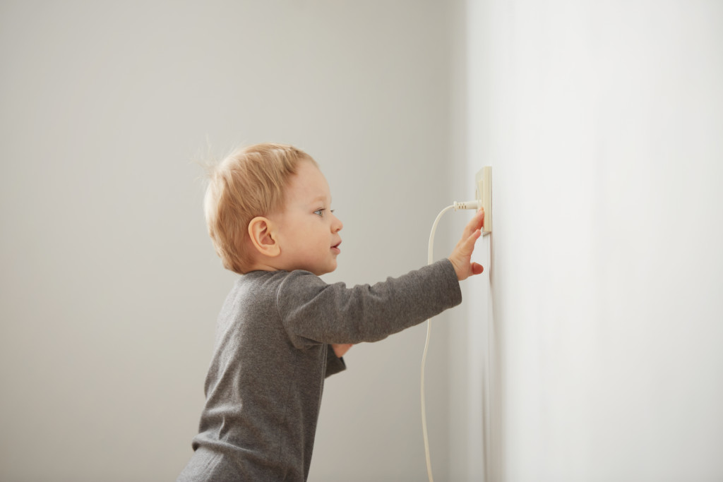 A boy playing with outlet