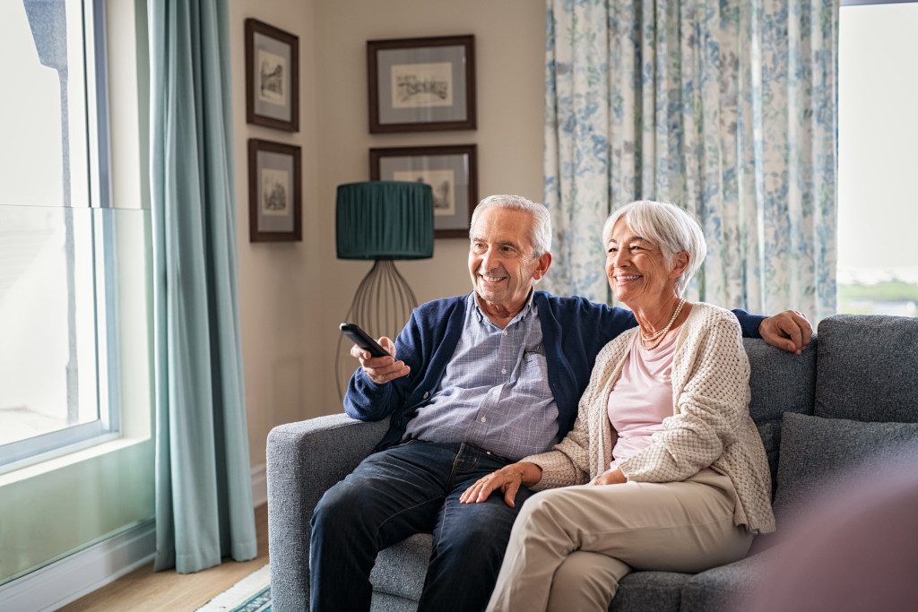 Elderly couple in the living room, watching television