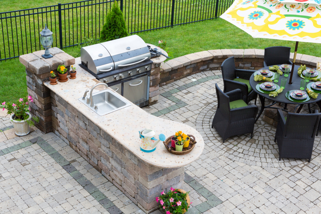 a beautiful outdoor kitchen with chairs and tables