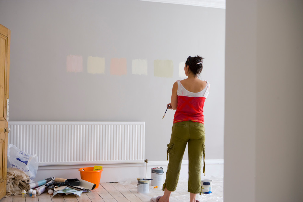 woman with a painted wall indoors with copy space.