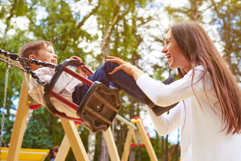 mom swinging her son