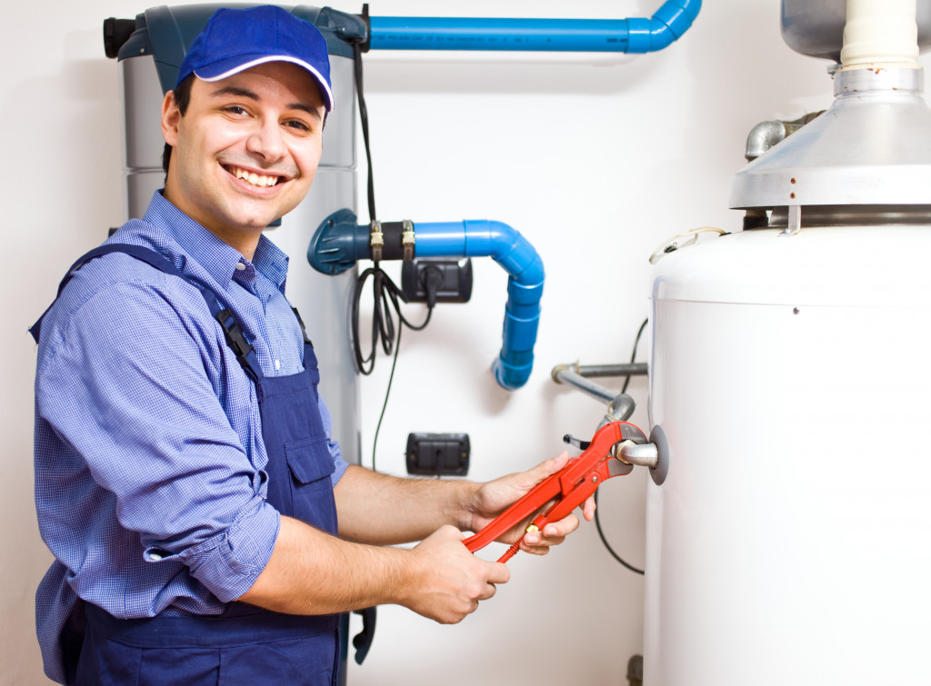 Professional technician fixing a home water heater.