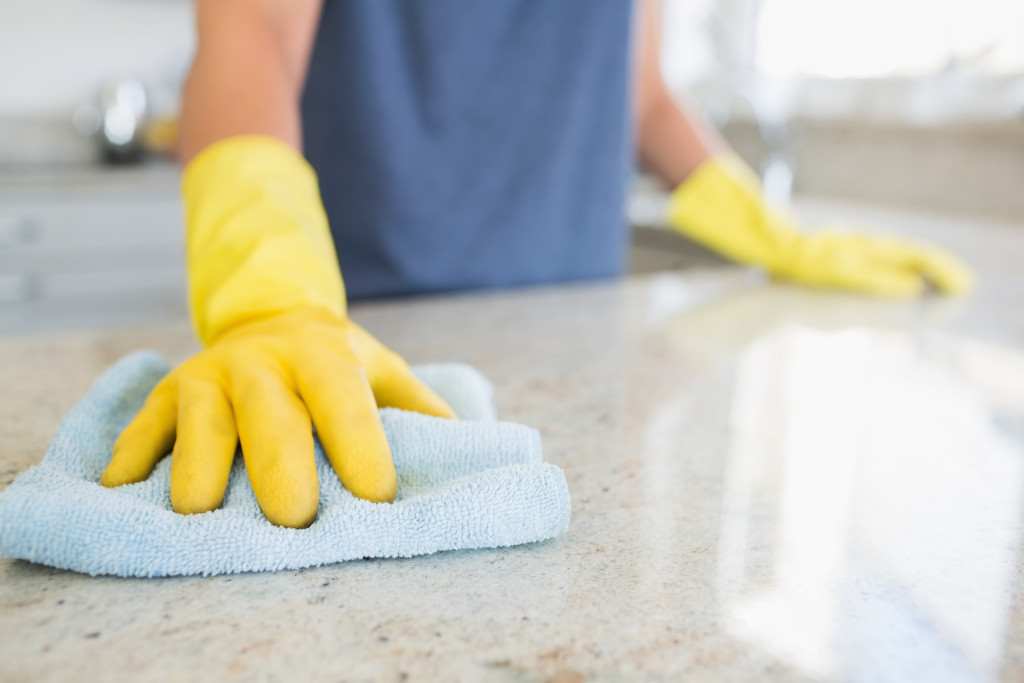 woman cleaning kitchen counter